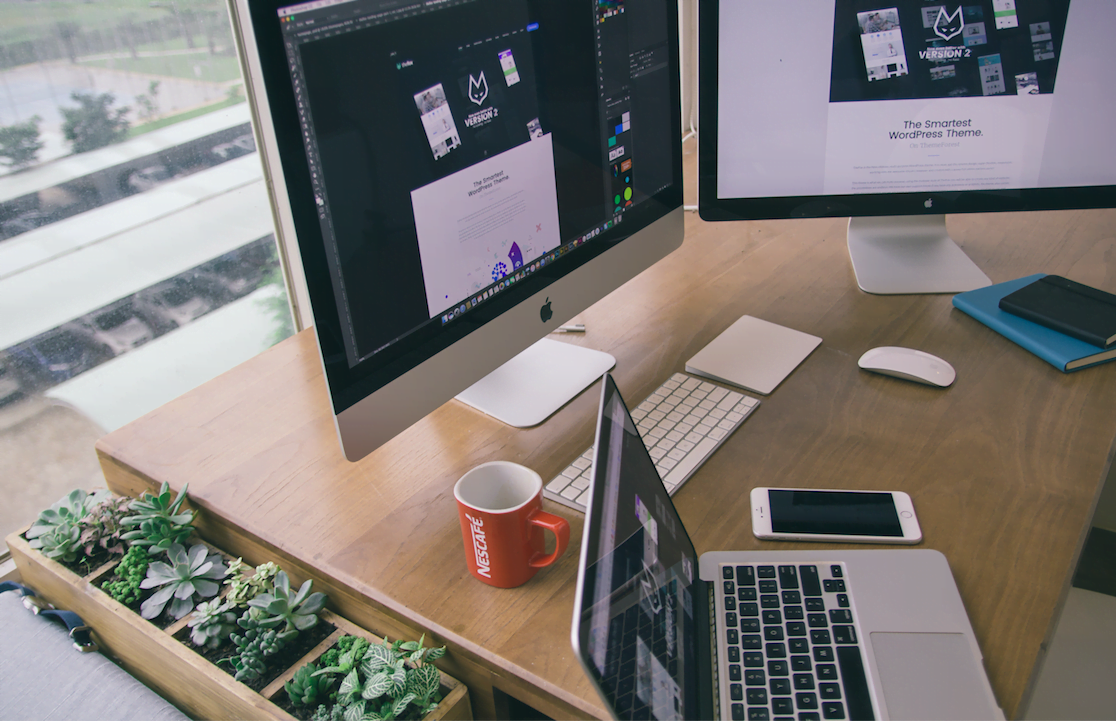 two-iMac-computers-on-a-desk-with-a-laptop-employees-work-from-home-remotely IT consulting services
