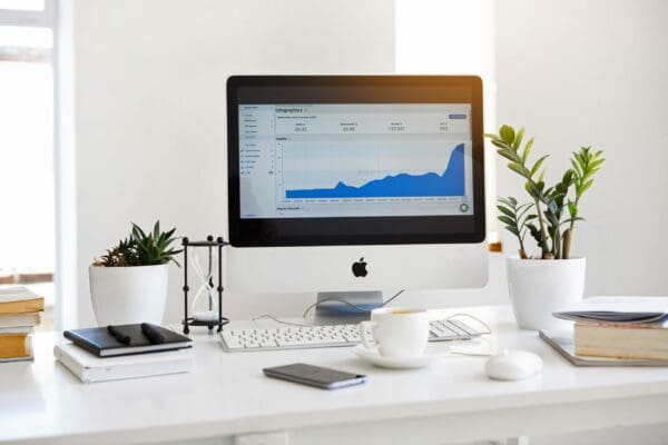 Apple iMac on a white desk in a modern office