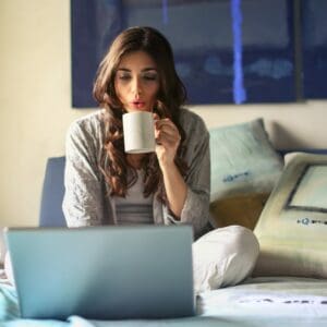 Working from home, woman working on laptop in bedroom, backup solution